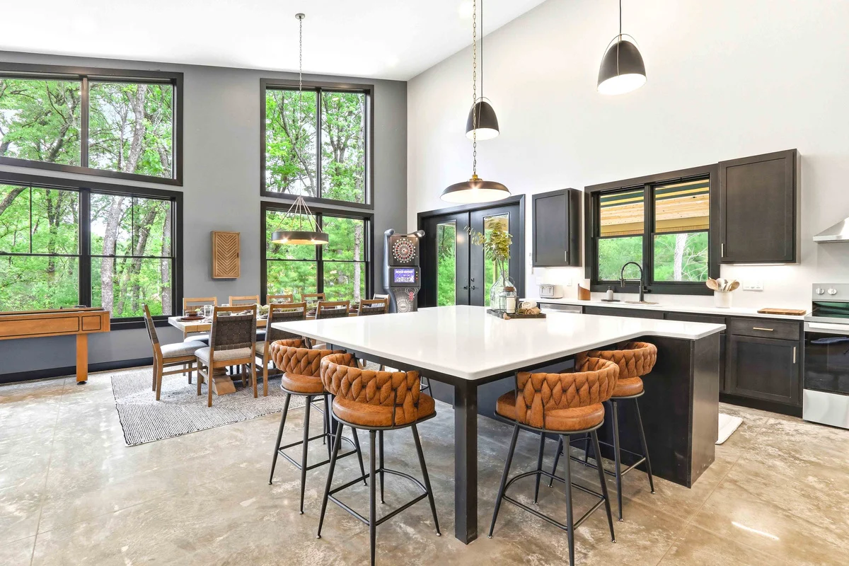 Modern open-concept kitchen with white quartz island and forest view in Nekoosa, Wisconsin
