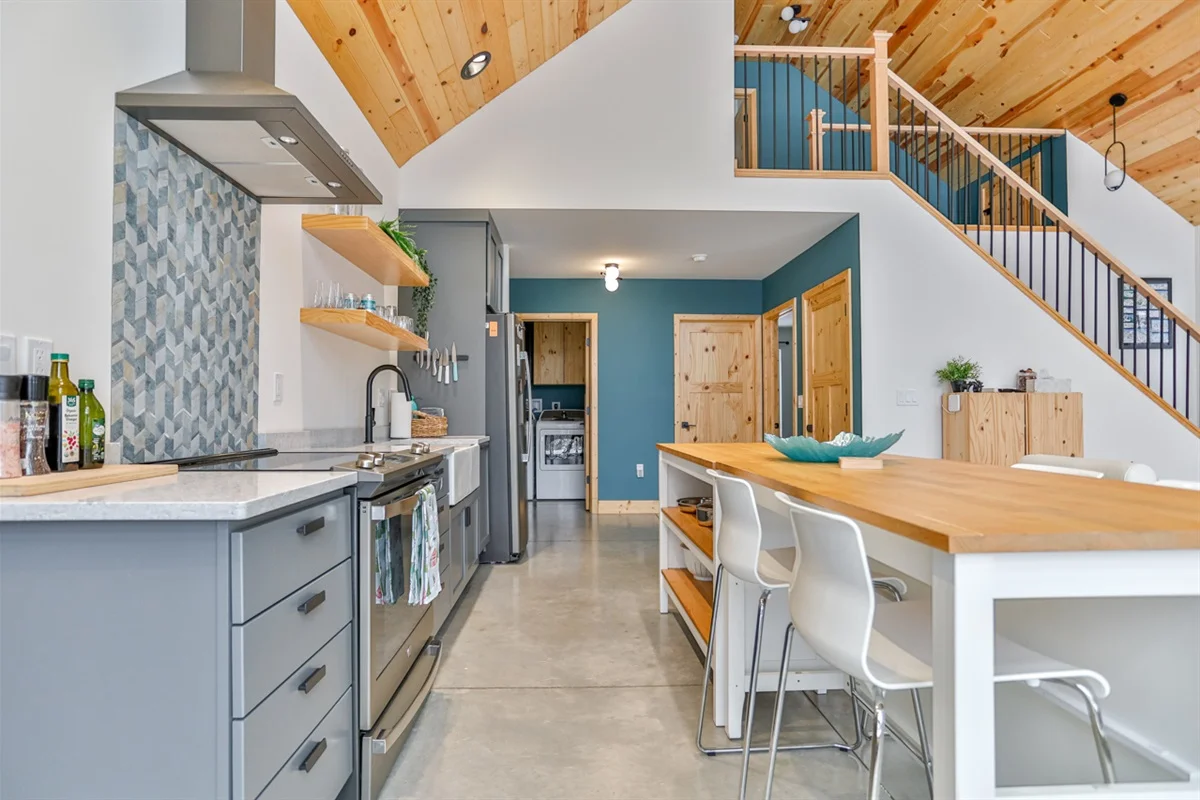 Modern kitchen with light blue cabinetry and island seating in Wausau vacation rental