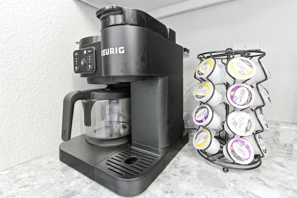 Black Keurig single-serve coffee maker with K-cup pods on quartz countertop at Wildwood Retreat