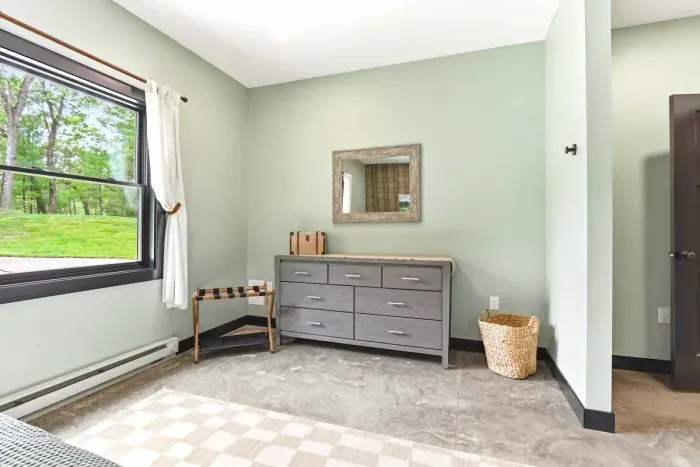 Unpack and settle in with ease in a calm, thoughtfully styled bedroom featuring generous storage and peaceful views just outside the window.