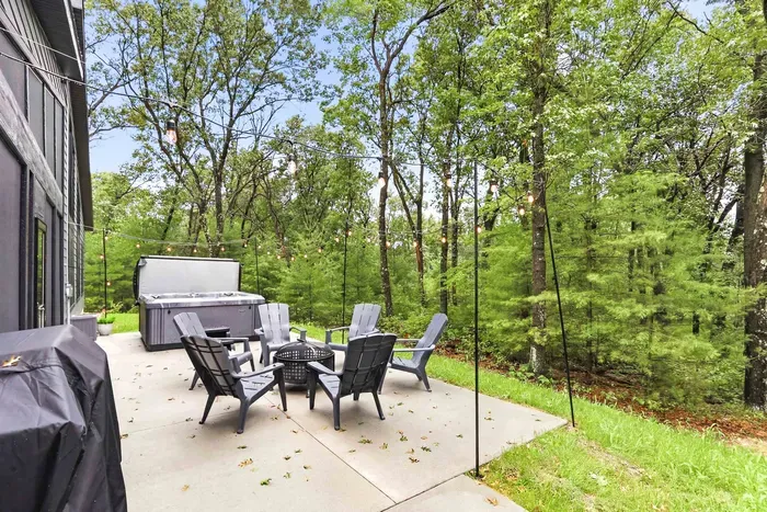 Spend your nights under the string lights with a hot tub, and wooded views all around.