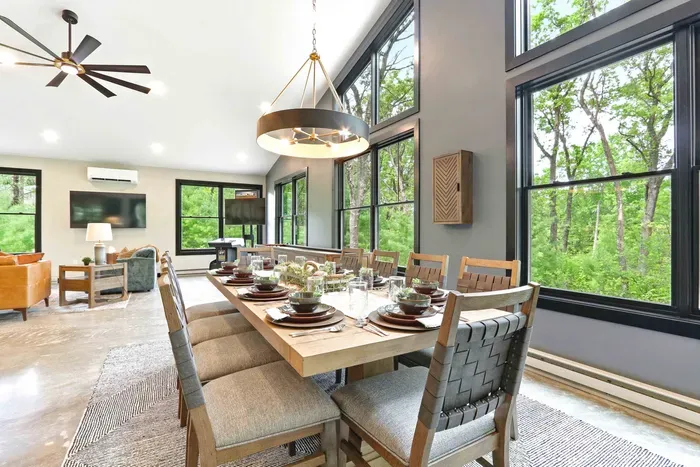 Gather around a beautifully set table framed by soaring windows and wooded views, where every meal feels relaxed, elevated, and effortlessly connected to nature.
