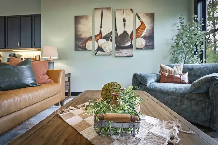Settle into a cozy lounge made for easy conversation, with warm textures, golf-inspired style, and a relaxed open flow just steps from the kitchen.