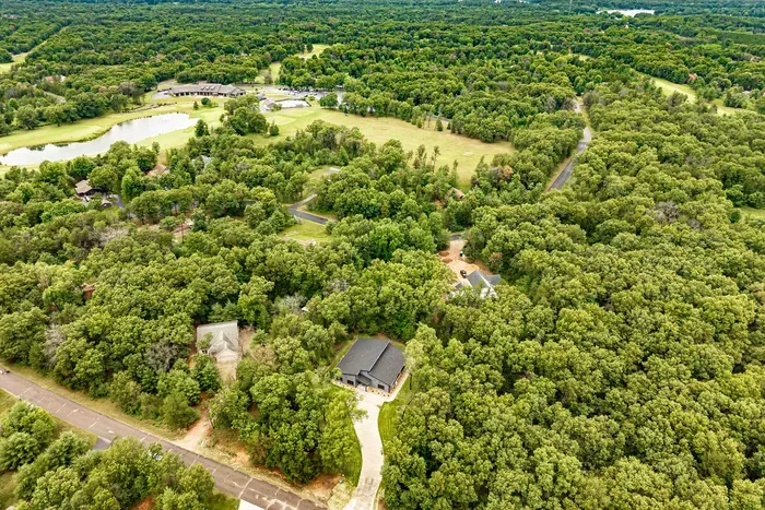 Escape to a private wooded setting with sweeping aerial views and nature all around.