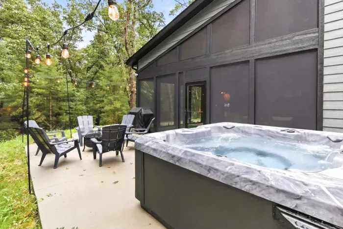 Hot tub evenings feel effortless here, with string lights, wooded views, and plenty of space to unwind outdoors.