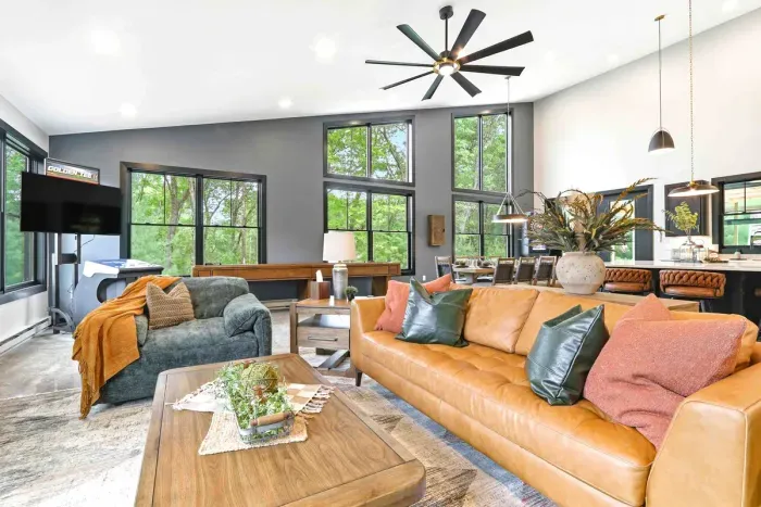 Lounge, dine, and play in one bright, open retreat where vaulted ceilings, treetop views, and cozy seating bring everyone together with ease.