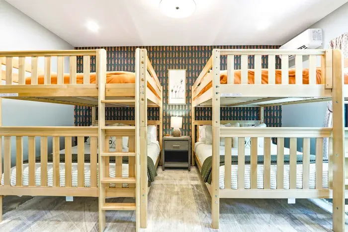 Perfect for kids or friends, this cheerful bunk space brings everyone together with comfortable beds and a fun, camp-inspired feel.