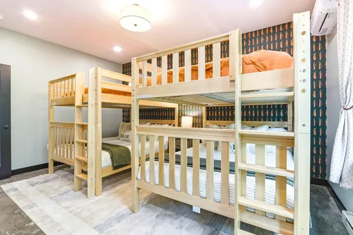 Recharge after a day of adventure in a bright bunk room made for laughter, late-night stories, and relaxed group stays.