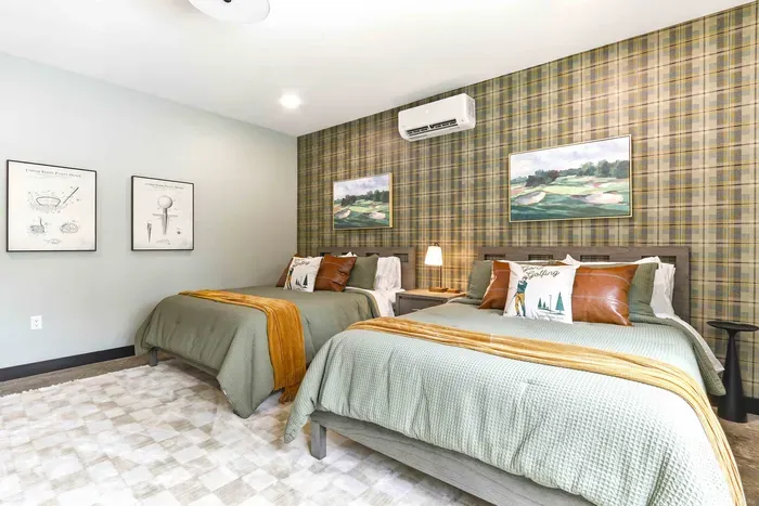 Settle into a stylish double-queen room with warm golf-inspired details, soft layers, and peaceful views just outside the window.