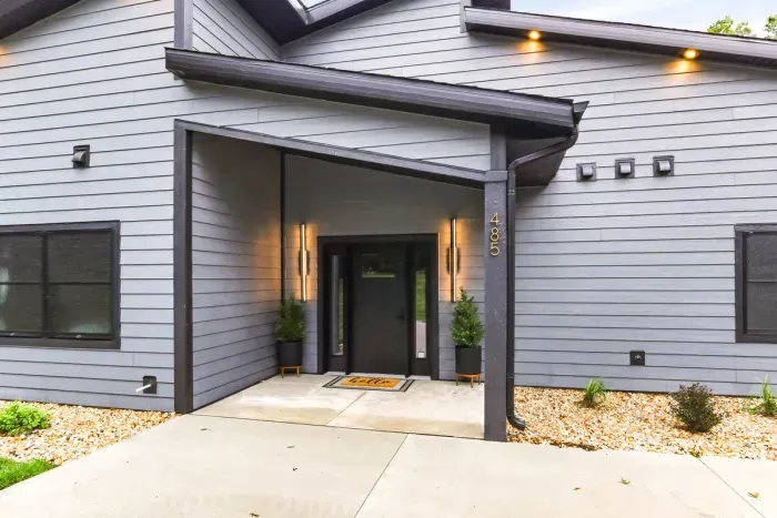 Step into a sleek modern entryway that sets the tone for a relaxing wooded getaway.
