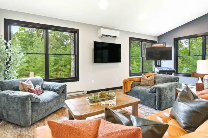 Sink into cozy seating, stream a favorite show, or enjoy a little friendly competition—all framed by peaceful treetop views.