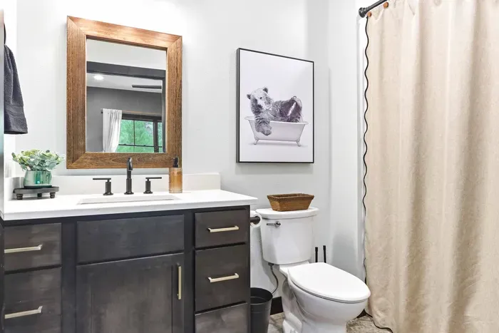 Refresh in a thoughtfully styled bath with warm rustic touches, sleek finishes, and a playful detail that makes the space feel inviting.