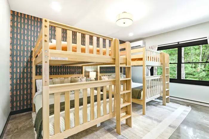 Let the group settle in with ease in a playful bunk room designed for cozy nights, easy mornings, and shared memories.