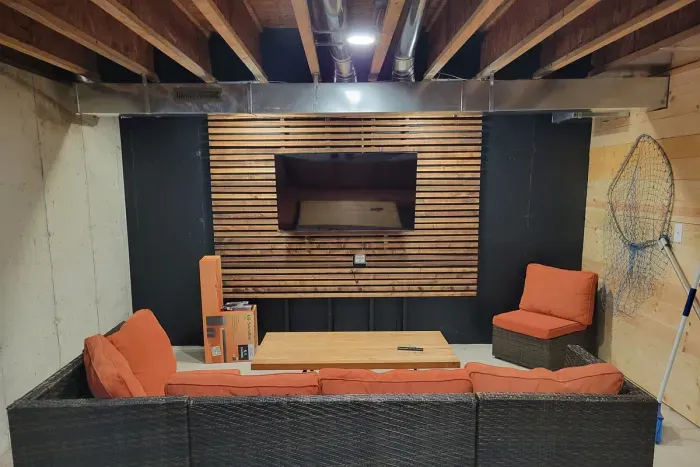 Gather for movie night in this cozy basement lounge, featuring warm wood accents, plush seating, and a big-screen setup made for laid-back evenings together.