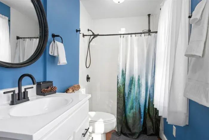 A fresh and vibrant bathroom with crisp white and soothing blue walls, creating a clean and relaxing atmosphere.