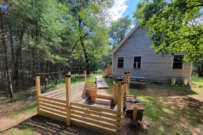 Step from the cabin into a private woodland firepit area, made for sunny afternoons, starlit evenings, and easy outdoor connection.