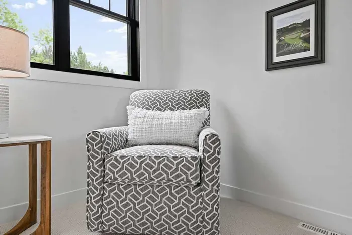 Soft armchair by the window, perfect for reading or quiet moments