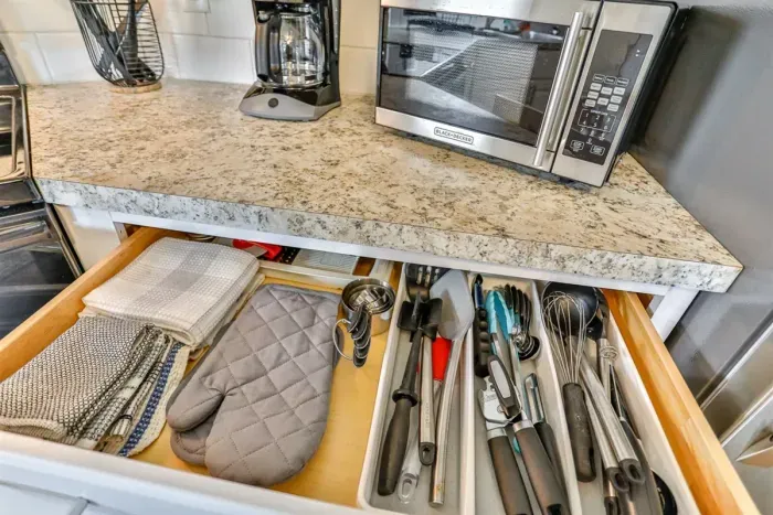 Convenient kitchen drawer storage with utensils, linens, and cooking essentials organized for easy everyday use.