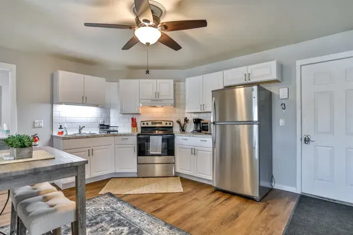 Well-designed kitchen and dining area with updated finishes, warm wood-style flooring, and a practical layout that keeps everything within easy reach.