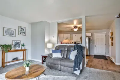 Inviting and well-appointed living area with soft natural light, cozy carpeting, and an open sightline into the kitchen for easy everyday living.