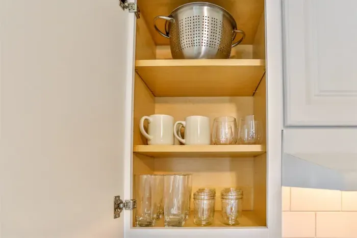 Well-organized kitchen cabinetry offering convenient storage for cookware, glassware, and everyday dining essentials.