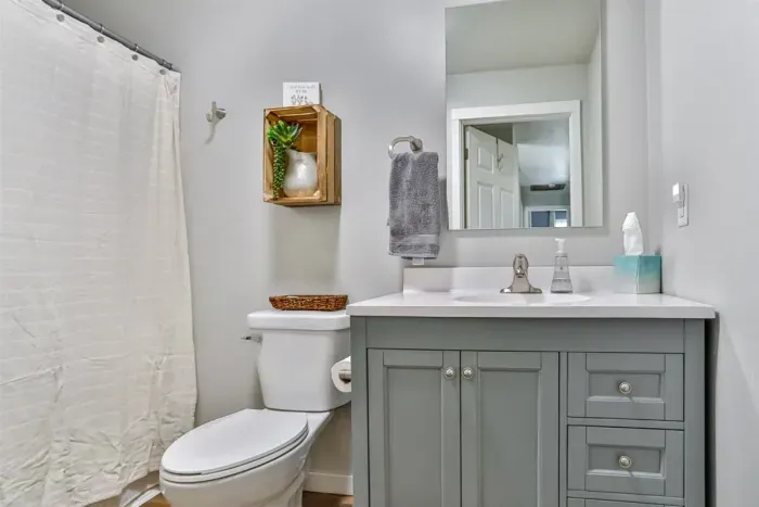 Clean and well-appointed bathroom featuring a modern vanity, tub/shower combo, and tasteful neutral finishes.