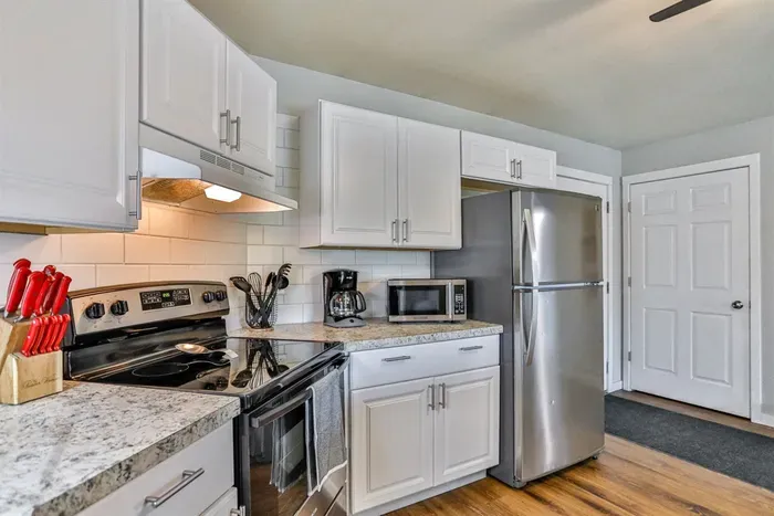 Efficient kitchen layout with ample cabinet storage, sleek appliances, and a comfortable dining setup perfect for everyday living.