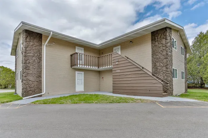 Well-maintained exterior with private entry access, covered walkways, and convenient parking just steps from the building.