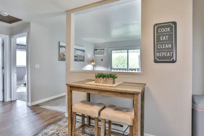 Cozy eat-in nook with bar-style seating and an open pass-through that keeps the kitchen and living areas connected.
