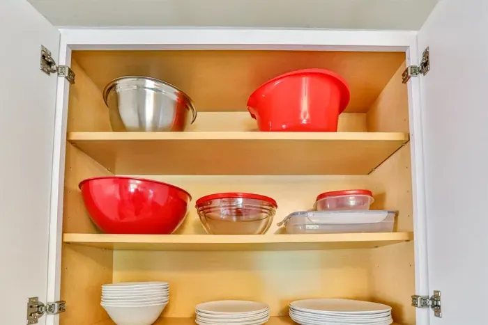 Ample kitchen cabinet storage with open shelving, dishware, and everyday essentials neatly organized for convenient use.