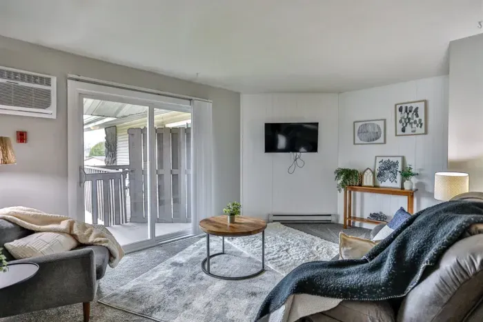 Comfortable main living space highlighted by a large slider, warm neutral tones, and a welcoming layout for everyday living.