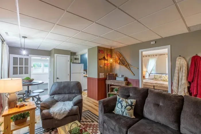 Indulge in comfort and style in our living room, featuring plush sofas, and elegant chairs. Cozy up by the fireplace, and unwind with entertainment on the TV.