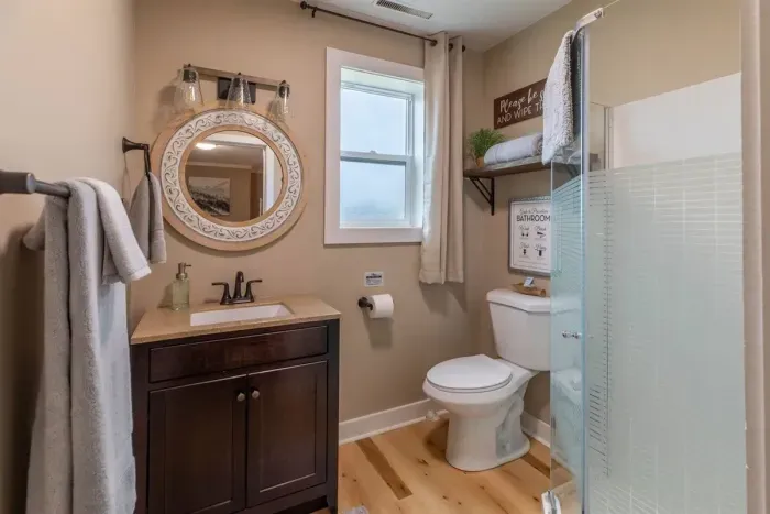 Experience modern convenience in our Airbnb with a pristine bathroom featuring a sleek toilet. Unwind in a clean and stylish space, ensuring a refreshing and comfortable stay throughout your visit.