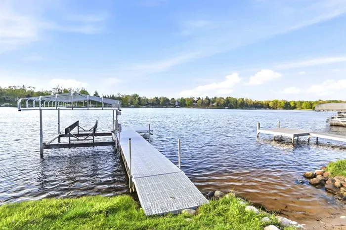 Relaxing lakeside backdrop with wide-open views, grassy yard space, and a calm shoreline atmosphere.