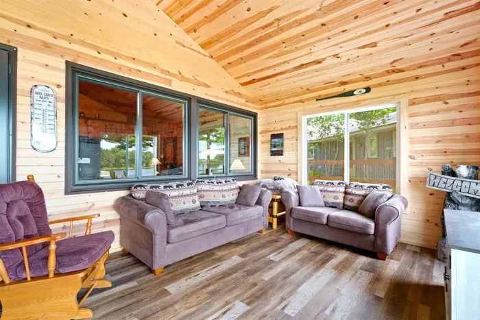A sun-filled porch bathed in natural light, perfect for relaxing with a book or enjoying morning coffee while soaking in the surrounding views.