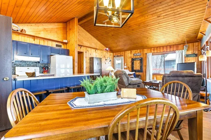Stylish Kitchen with Blue Accents, Bar Seating & Dining Table