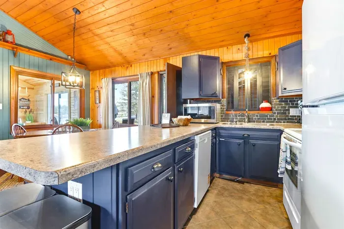 Spacious Kitchen with Blue Cabinets & Cozy Counter