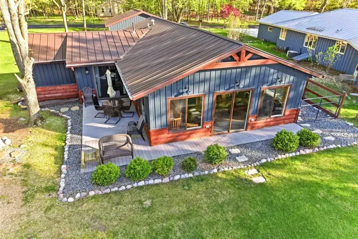Beautiful waterfront setting with clear shallow shoreline, private dock space, and open yard area for lakefront enjoyment.