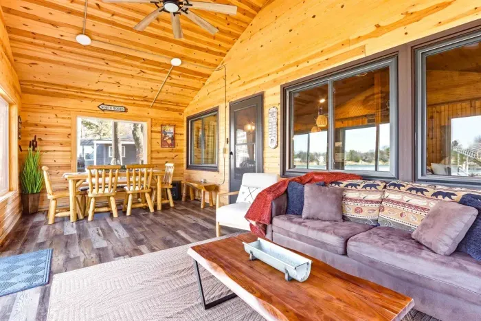 Peaceful Sun Porch with Plush Seating & Side Table