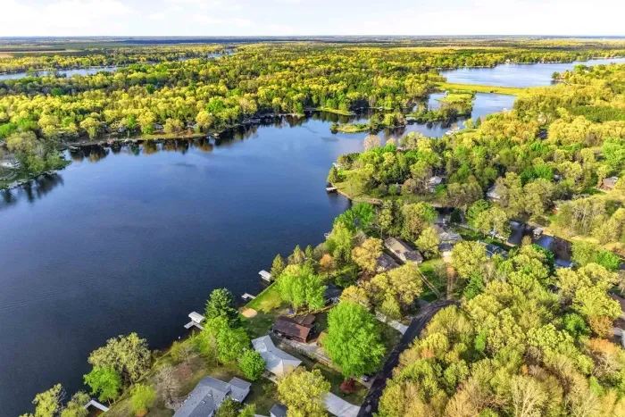 Picturesque waterfront backdrop with open water, lush greenery, and peaceful cottage-style surroundings.