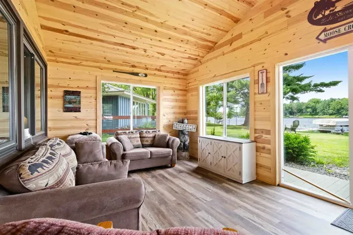 A sun-filled porch bathed in natural light, perfect for relaxing with a book or enjoying morning coffee while soaking in the surrounding views.