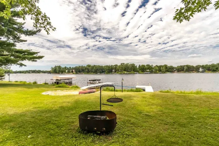 Private lakefront getaway in Nekoosa, WI with open green space and relaxing outdoor views.