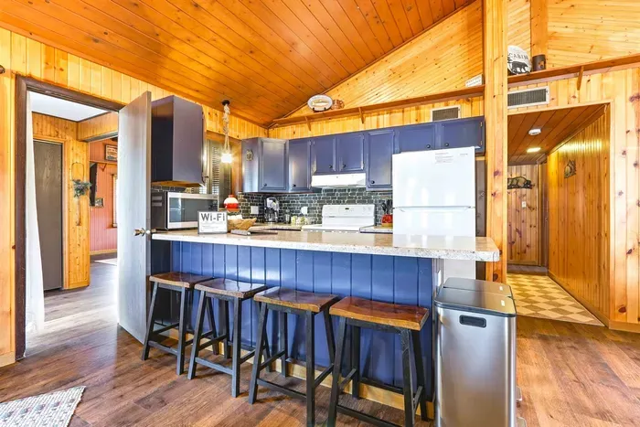 Modern Kitchen with Blue Cabinets & Stylish Bar Counter