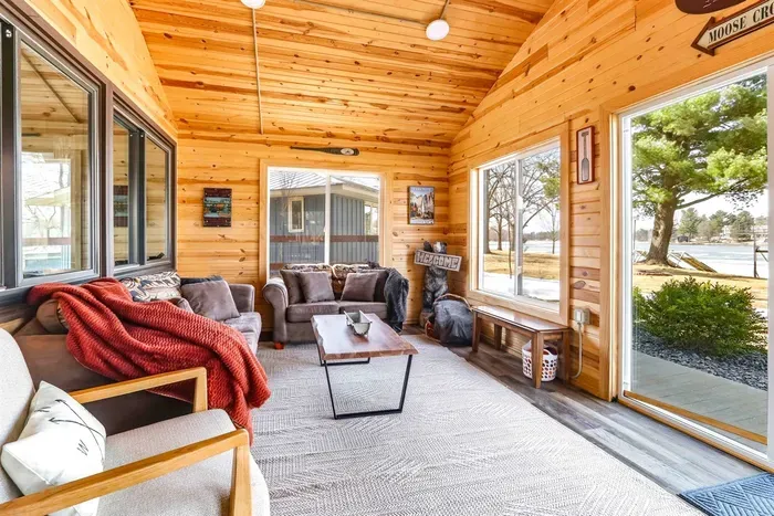 Modern Sunroom with Natural Light, Couch & Wooden Touches