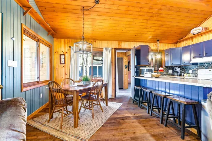 Spacious Kitchen with Blue Cabinets, Cozy Bar & Dining Table