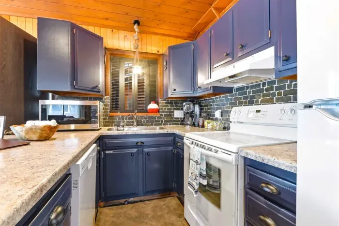 Contemporary Kitchen with Blue Accents & Bar Seating