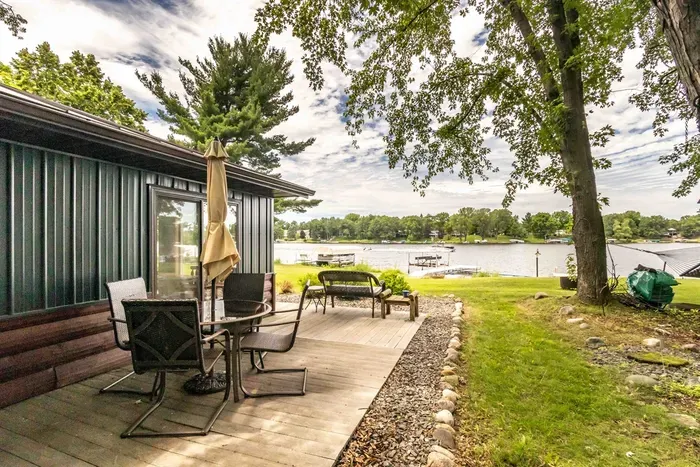 Nekoosa, WI lakefront stay with large yard, trees, and relaxing getaway vibes.