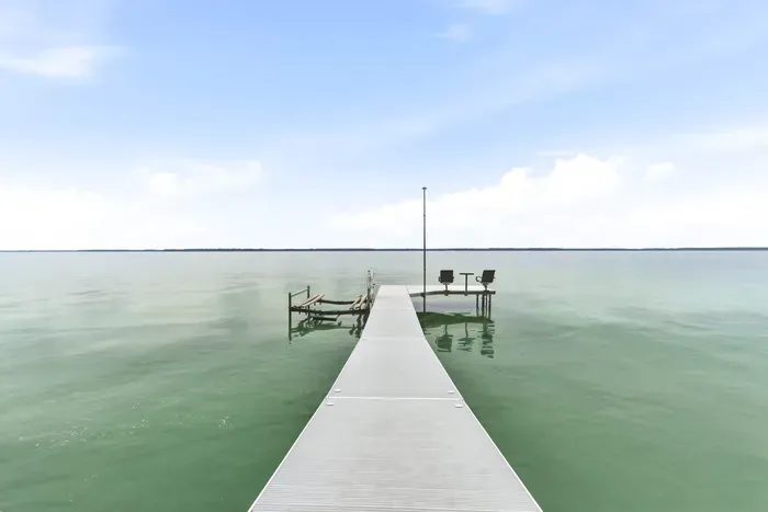 Spend endless summer days swimming and fishing off the private boat dock, complete with an outdoor seating area overlooking the tranquil, open lake waters.