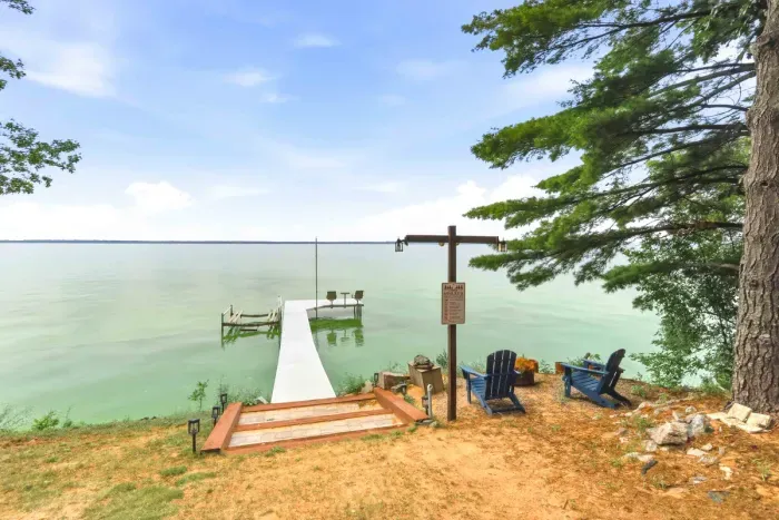 Step down to the water’s edge and soak in panoramic views from your private boat dock with seating, or relax waterfront in cozy Adirondack chairs under the shade of mature pines.
