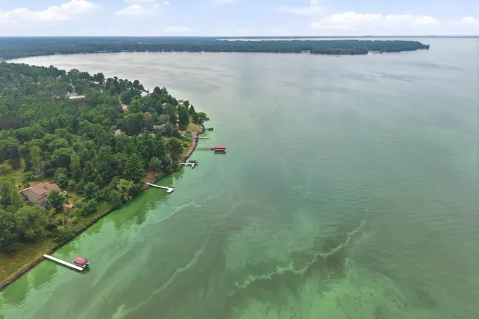 Nestled along a peaceful, tree-lined bay, this prime waterfront location offers direct access to swimming, boating, and fishing right from your backyard.